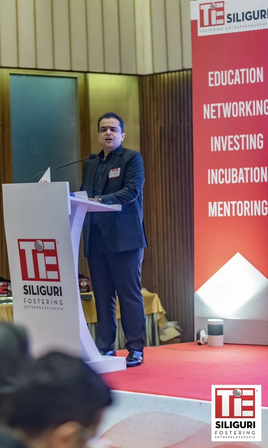 A speaker addressing the audience at a TiE Siliguri session